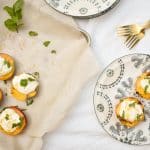 grilled peaches with honey ricotta on sheet pan with two on blue flowered plate