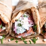 Greek salmon gyros with tzatziki and pickled onions