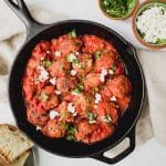 overhead shot of greek turkey meatballs with feta cheese in cast iron pan