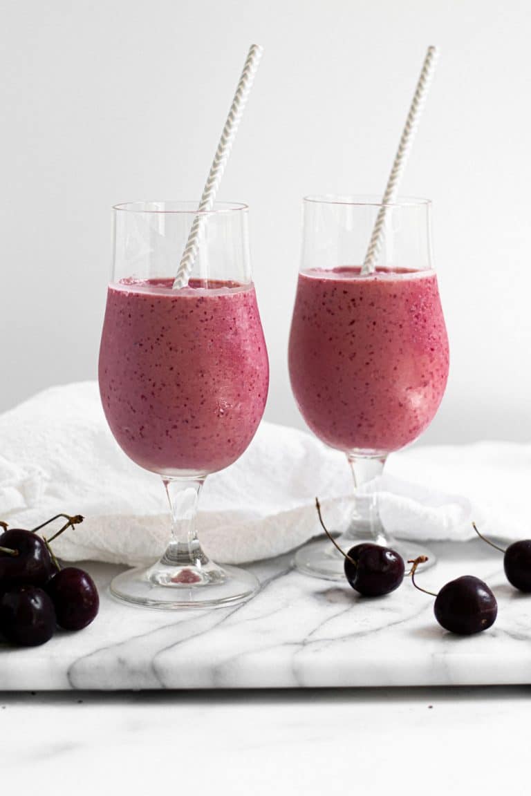 2 cherry vanilla smoothies on marble background